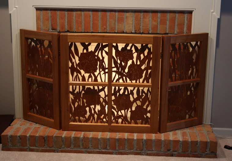 Here's an outstanding Mahogany Fireplace Screen Keith made recently. Careful cutouts are silhouetted by the light behind t he screen.